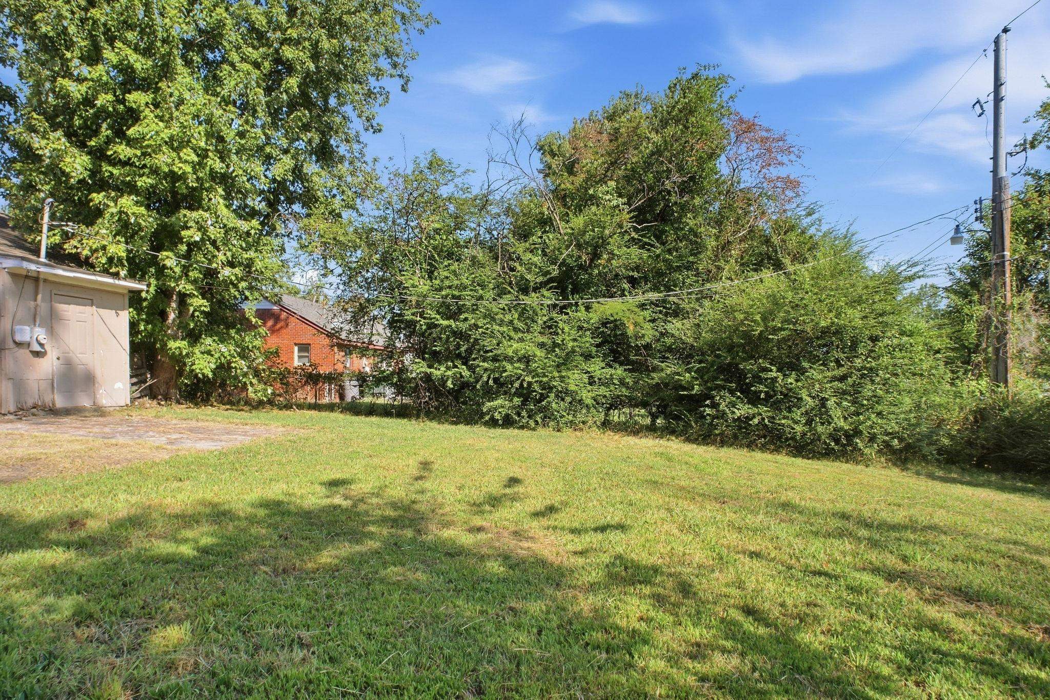 4562 Tulane Road Memphis, TN 38109 - Photo 32 of 32 Expansive grassy yard with varied mature trees