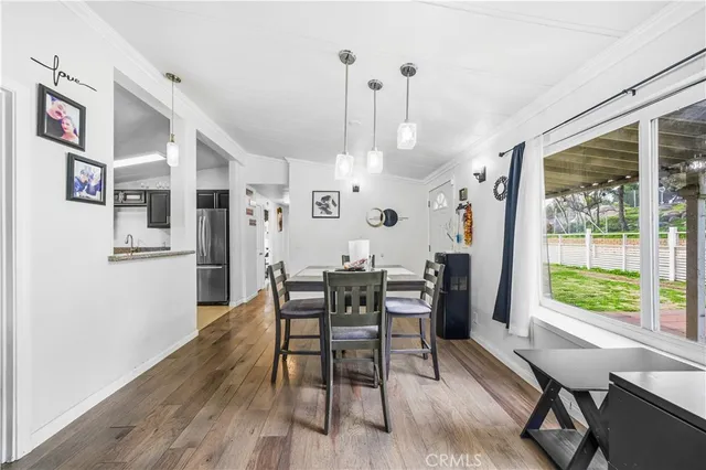 a view of a dining room with furniture window and wooden floor
