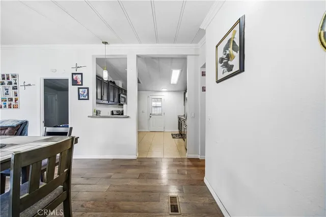 a view of a kitchen with furniture and an empty room