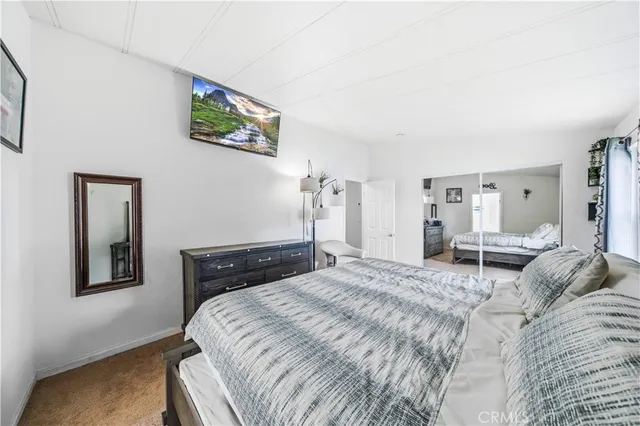 a bedroom with a bed and a painting on the wall