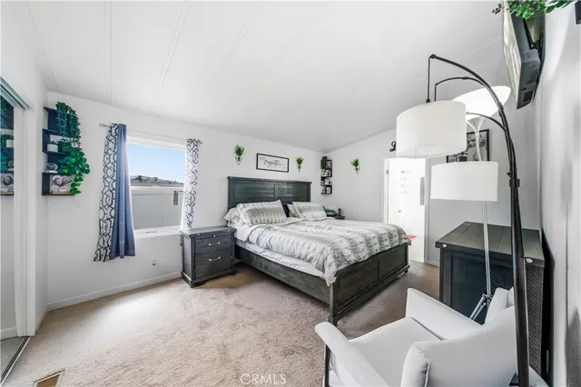 a bedroom with a bed couch and window