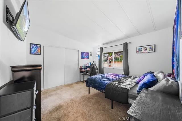 a bed room with a bed and a television