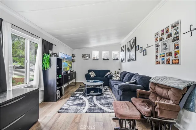 a living room with furniture fireplace and large window