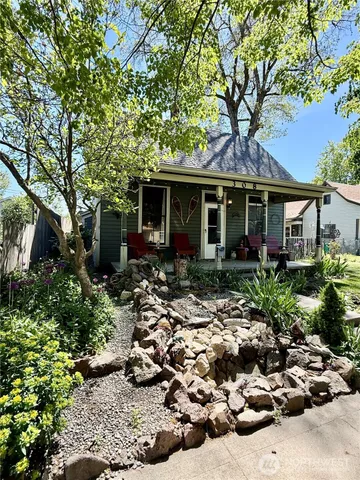 a front view of a house with a garden