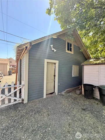 a view of house with yard and outdoor seating