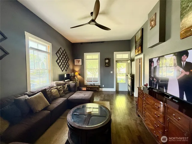 a living room with furniture a window and a chandelier