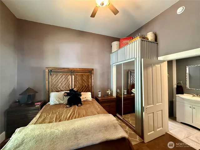 a bedroom with a bed and a chandelier