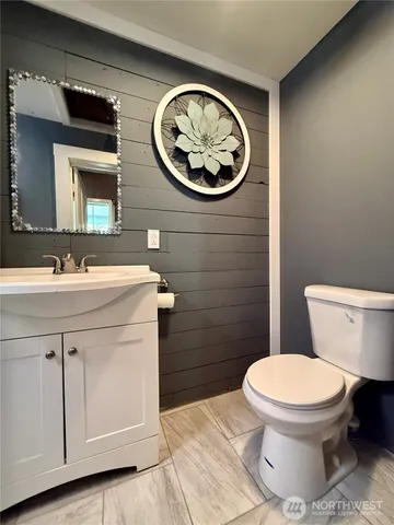 a bathroom with a toilet a sink and a mirror