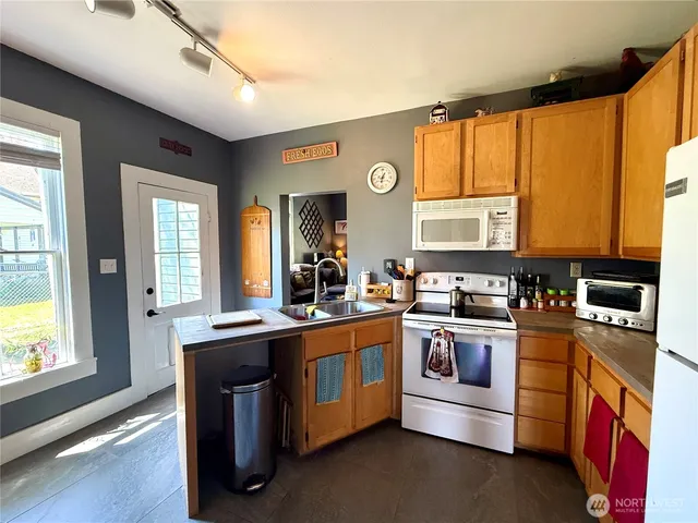 a kitchen with stainless steel appliances granite countertop a stove and a sink