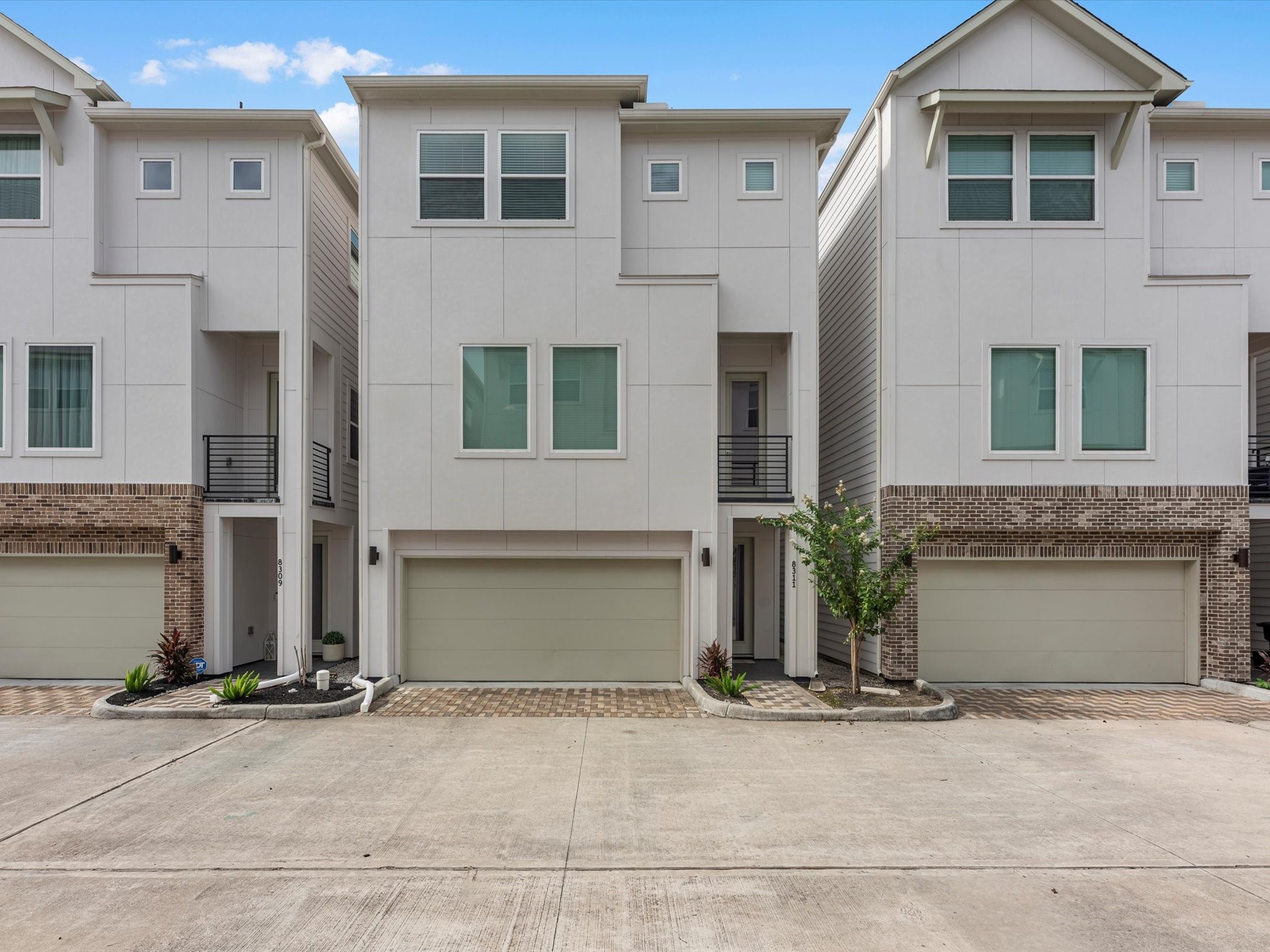 a front view of a house with a yard and a garage