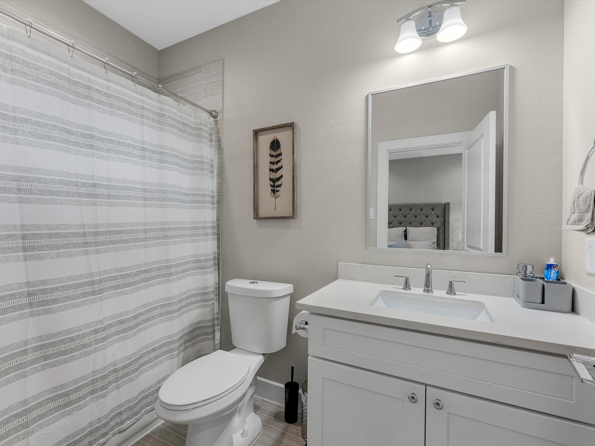 8311 Brecha Lane Houston, TX 77055 - Photo 15 of 19 a bathroom with a toilet a sink and mirror