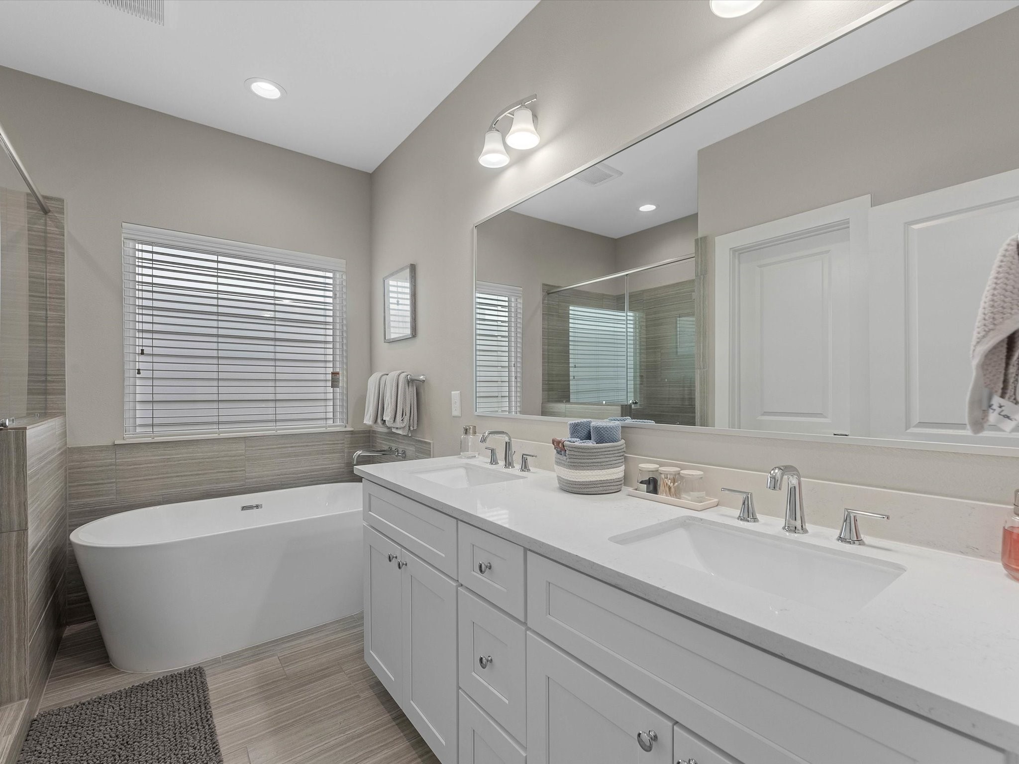 8311 Brecha Lane Houston, TX 77055 - Photo 10 of 19 a bathroom with a large tub sink and mirror