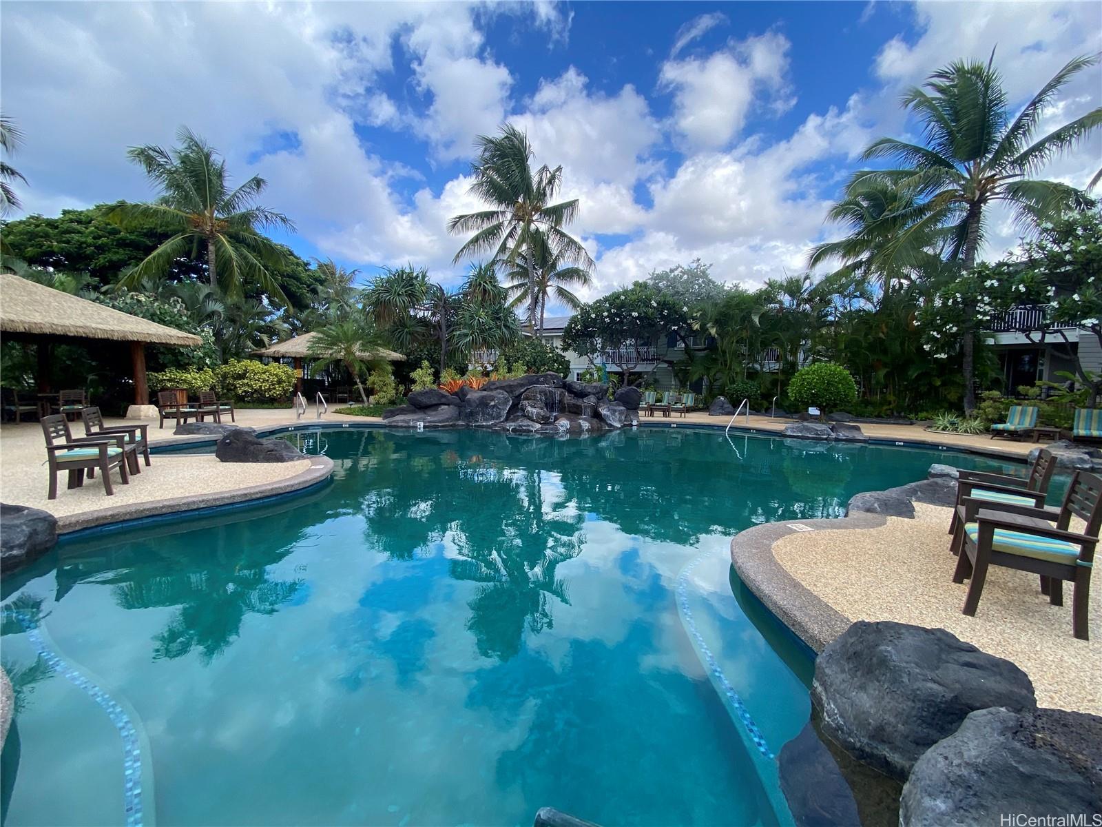 92-1037 Koio Drive, Unit M11 Kapolei, HI 96707 - Photo 1 of 11 a swimming pool with outdoor seating and yard