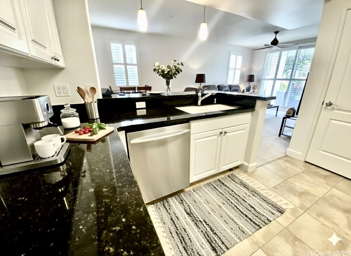 92-1037 Koio Drive, Unit M11 Kapolei, HI 96707 - Photo 4 of 11 a kitchen with a sink and cabinets