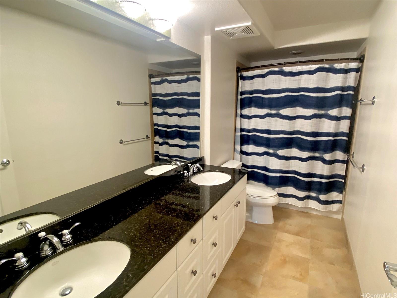 92-1037 Koio Drive, Unit M11 Kapolei, HI 96707 - Photo 7 of 11 a bathroom with a granite countertop sink a toilet and shower