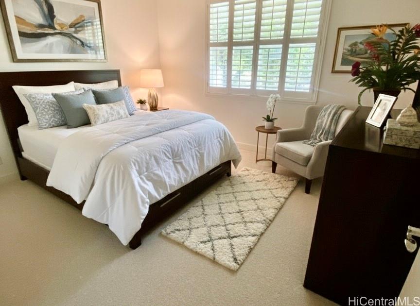 92-1037 Koio Drive, Unit M11 Kapolei, HI 96707 - Photo 8 of 11 a bedroom with bed and a couch