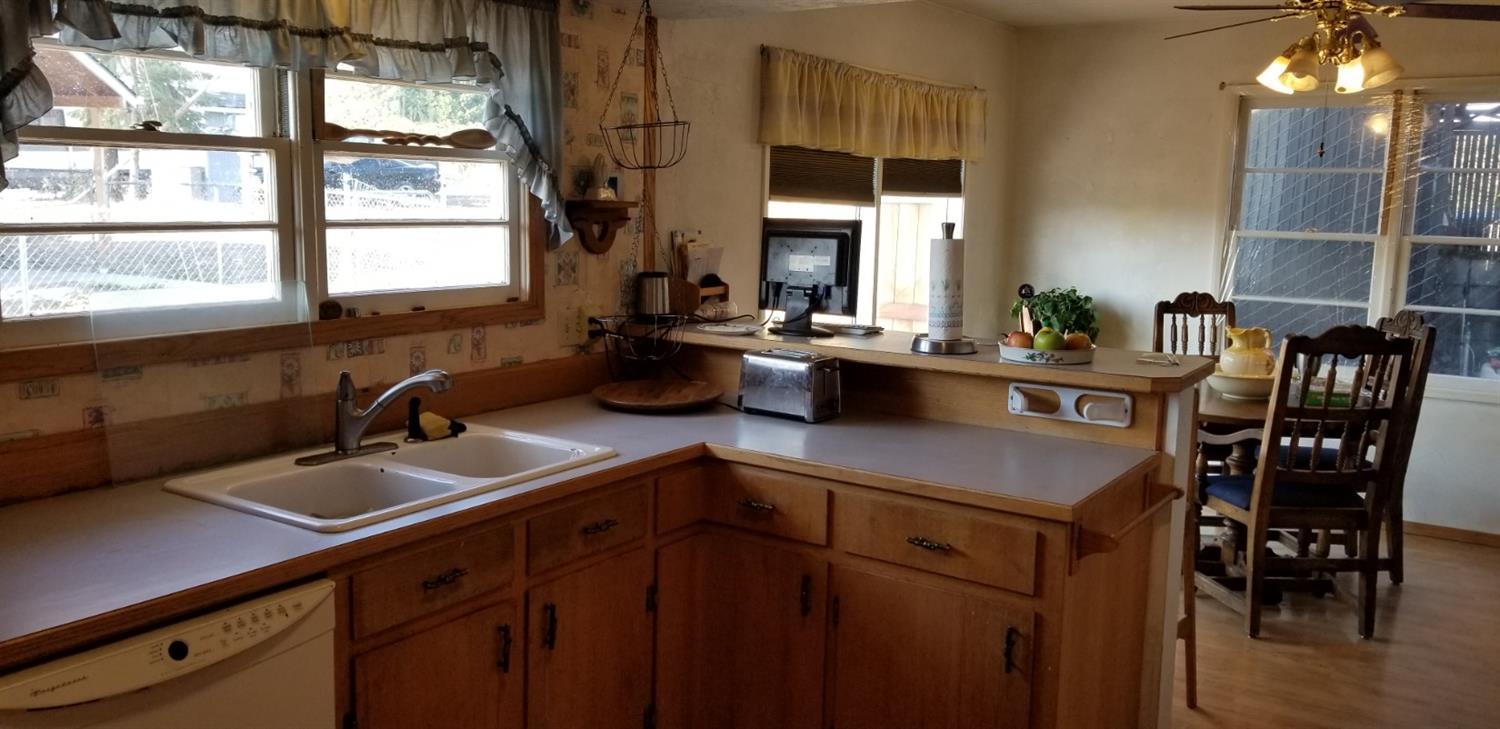 2492 Stevens Road Eagle Point, OR 97524 - Photo 4 of 15 a kitchen with a sink a counter top space and living room area