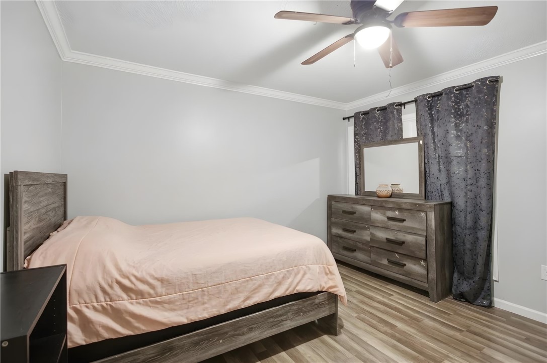 311 Cumberland Way Anderson, SC 29621 - Photo 18 of 44 Well-lit sleeping quarters with a ceiling fan, crown molding, and resilient flooring.