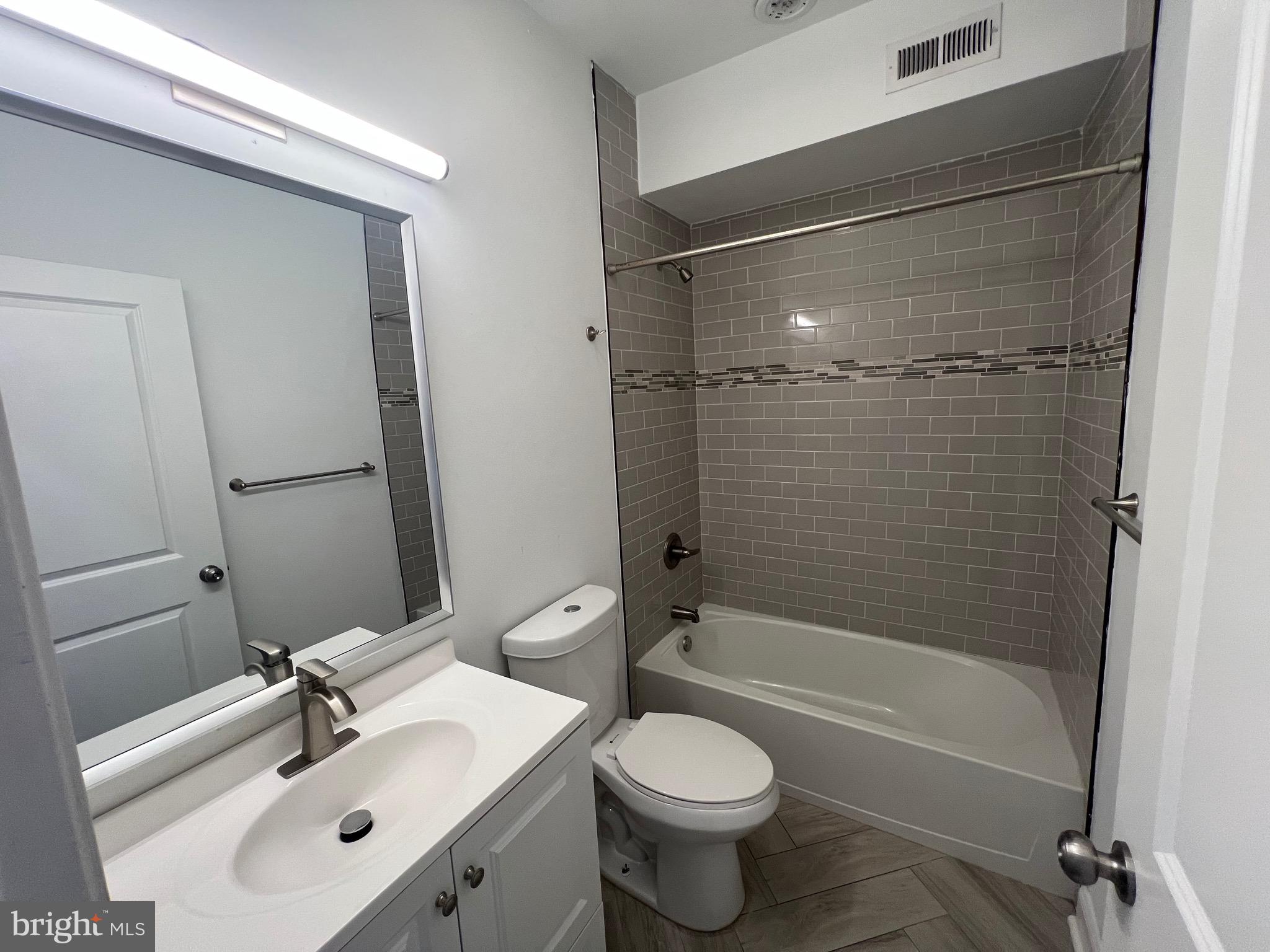 1829 North 33rd Street, Unit 4 Philadelphia, PA 19121 - Photo 9 of 10 a bathroom with a sink toilet and shower