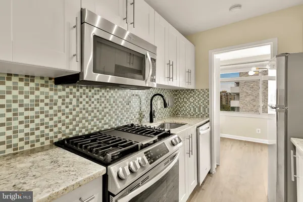 a kitchen with a stove and a microwave