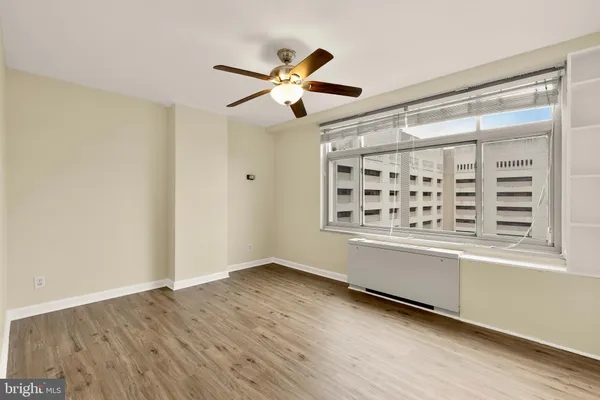 a view of a livingroom with a ceiling fan and wooden floor