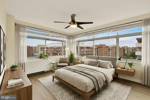 a bedroom with a large bed and a large window with outer view