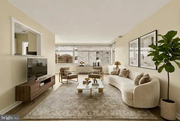 a living room with furniture a rug and a flat screen tv