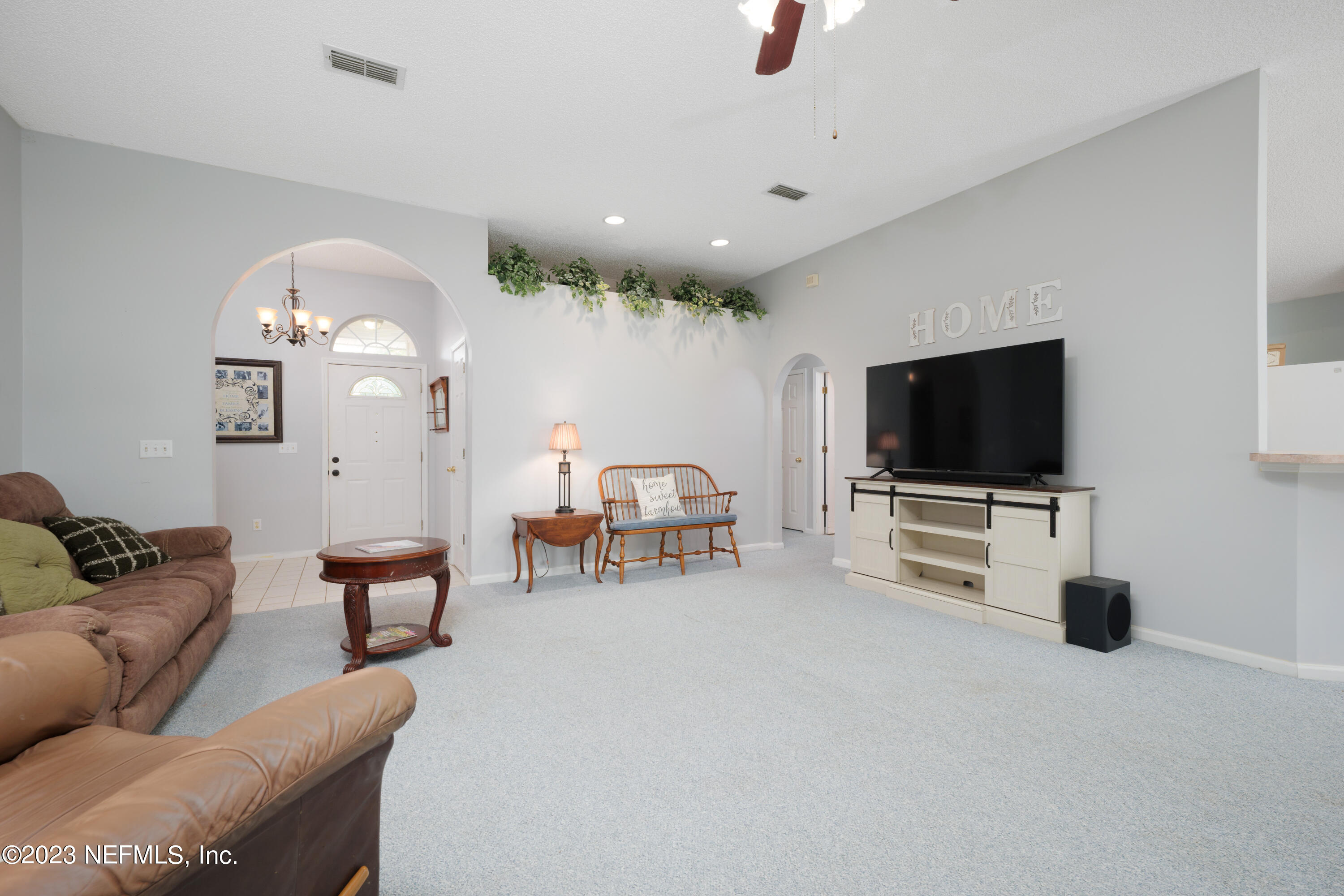12600 Moose Road Jacksonville, FL 32226 - Photo 8 of 28 a living room with furniture and a flat screen tv