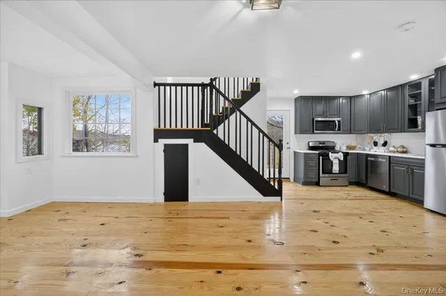 a view of kitchen with microwave and cabinets
