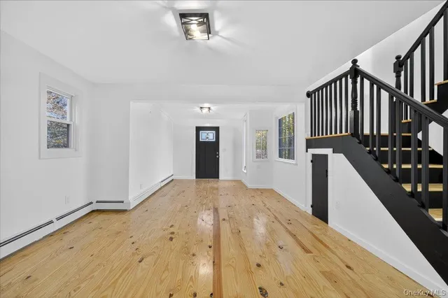 a view of an entryway with wooden floor