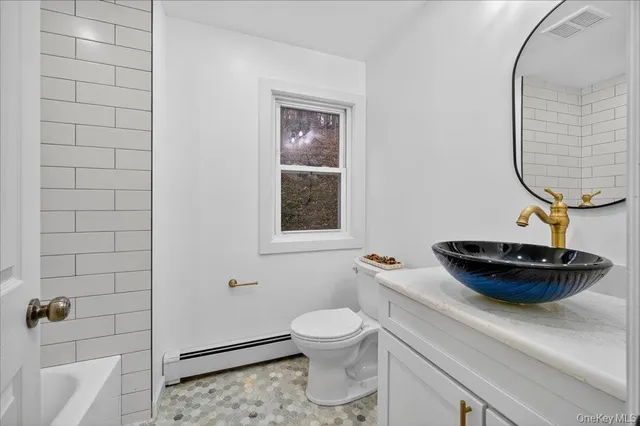 a bathroom with a toilet and a mirror