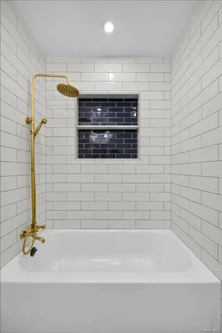 a bathroom with a bathtub and a shower