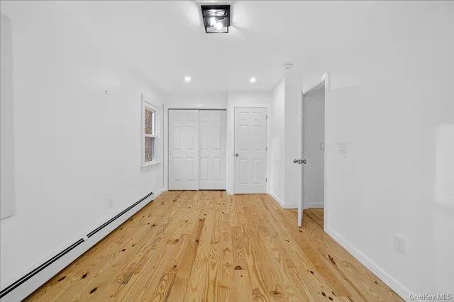 a view of a room with wooden floor and white walls