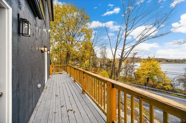 a view of balcony with wooden floor and fence