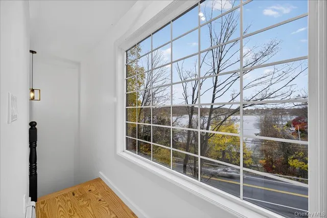 a view of a room with wooden floor and a window