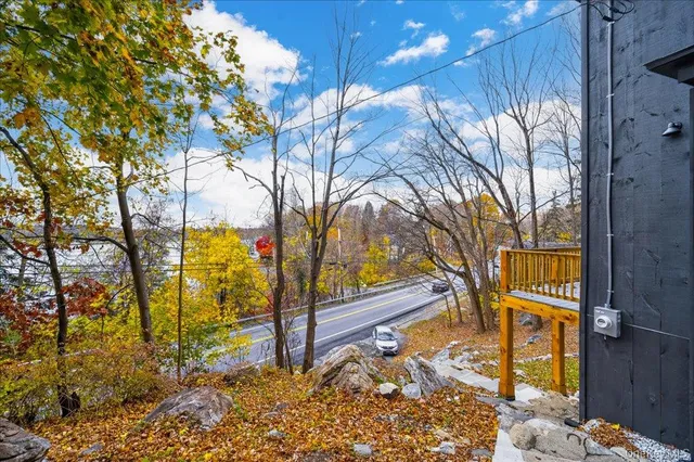 a view of a yard with wooden fence