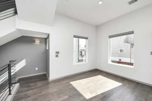 an empty room with windows and closet