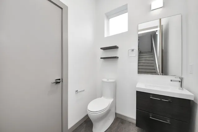 a bathroom with a sink a toilet and mirror