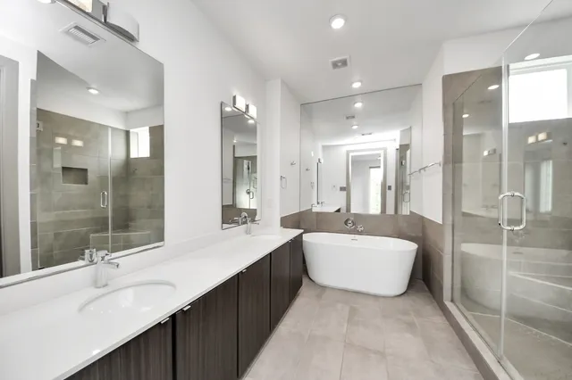 a large bathroom with a double vanity sink mirror and double