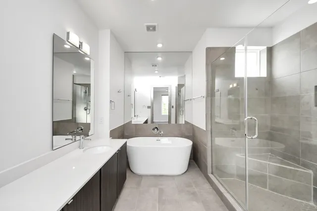 a bathroom with a double vanity sink mirror and shower