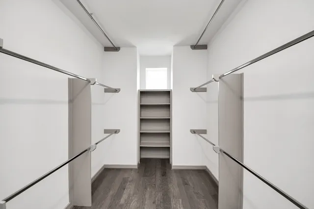 a view of walk in closet with empty racks