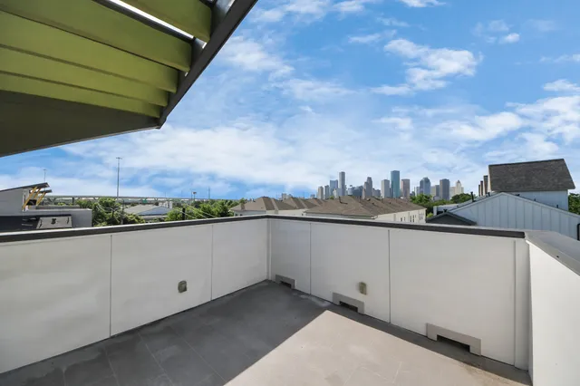 a view of a patio with table and chairs with wooden floor and fence