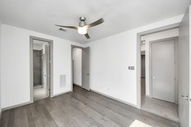 a view of empty room with wooden floor