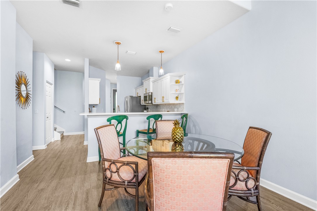 909 Bahia Mar Road Vero Beach, FL 32963 - Photo 9 of 36 a dining room with furniture and wooden floor