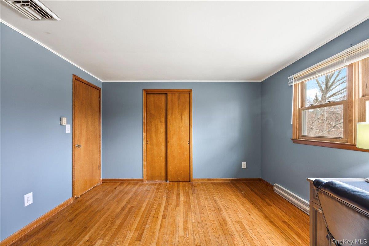 155 Mill Street Wallkill, NY 12589 - Photo 11 of 26 a view of empty room with a window and wooden floor