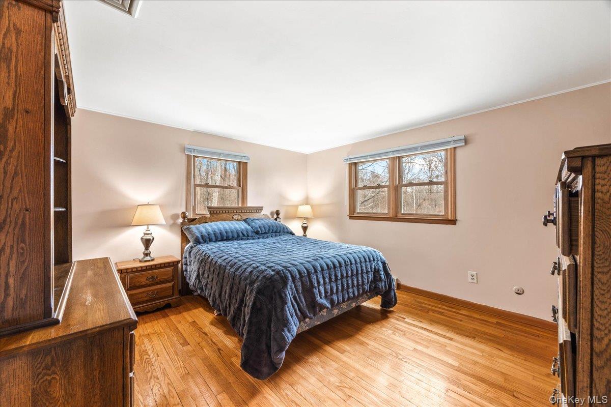 155 Mill Street Wallkill, NY 12589 - Photo 12 of 26 a bedroom with a bed and wooden floor