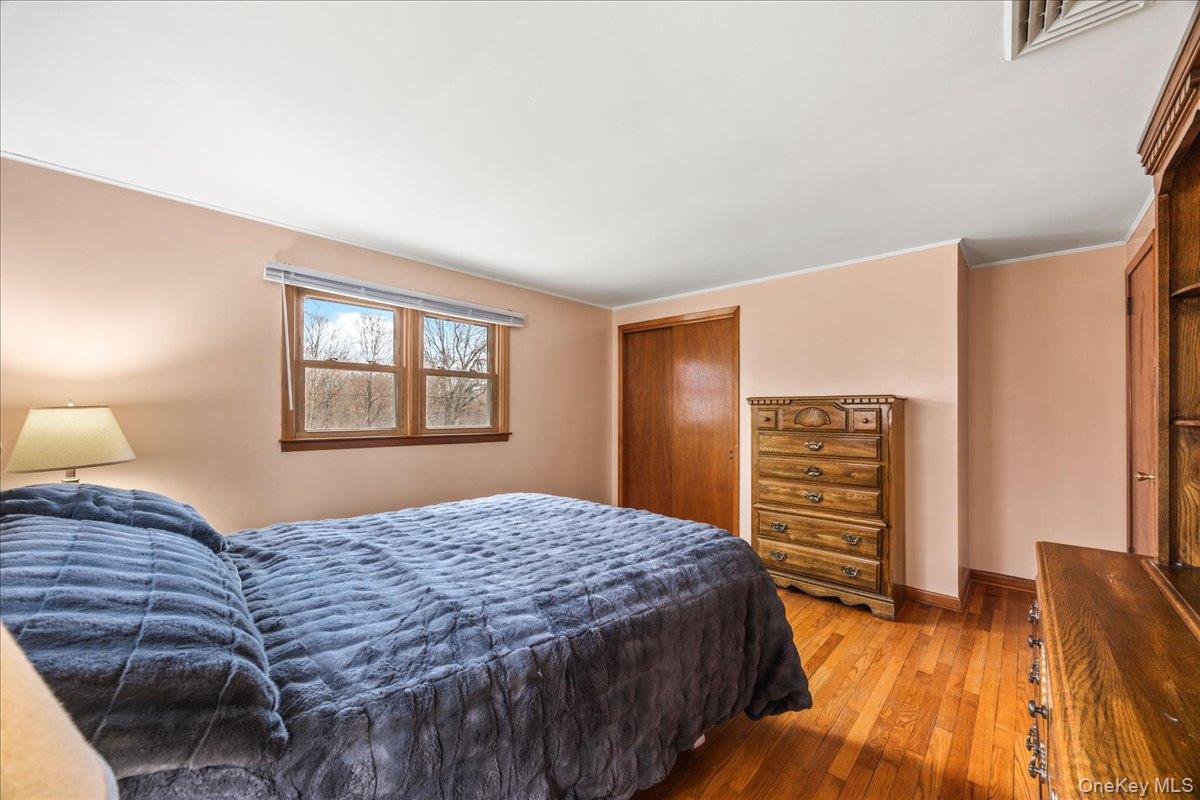 155 Mill Street Wallkill, NY 12589 - Photo 13 of 26 a bedroom with a bed and a dresser