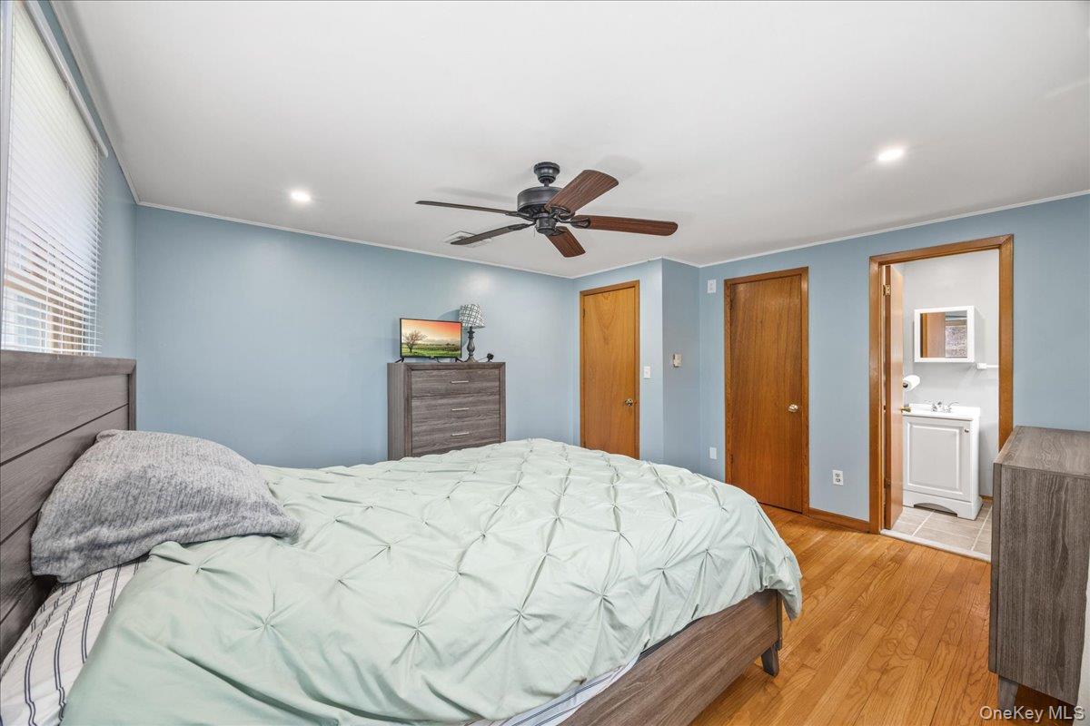 155 Mill Street Wallkill, NY 12589 - Photo 14 of 26 a bedroom with a bed and a chandelier