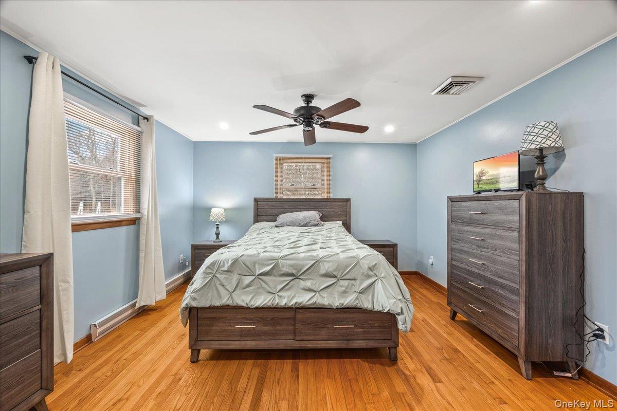 155 Mill Street Wallkill, NY 12589 - Photo 15 of 26 a bedroom with a bed and wooden floor