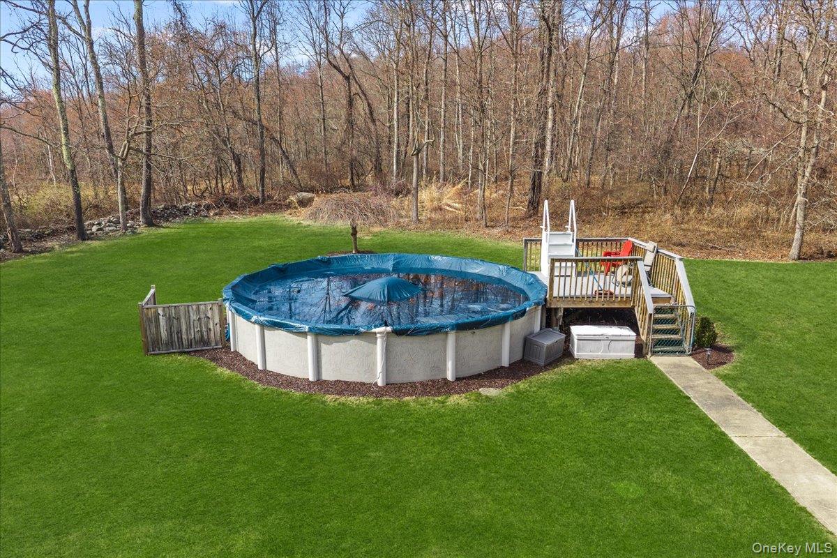 155 Mill Street Wallkill, NY 12589 - Photo 24 of 26 a view of a backyard with sitting area and bench